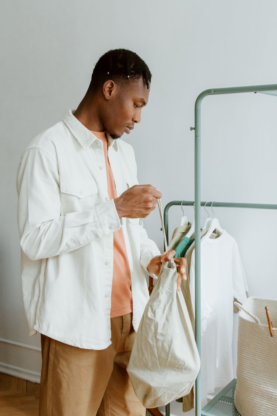 Man arranging clothes on a rack