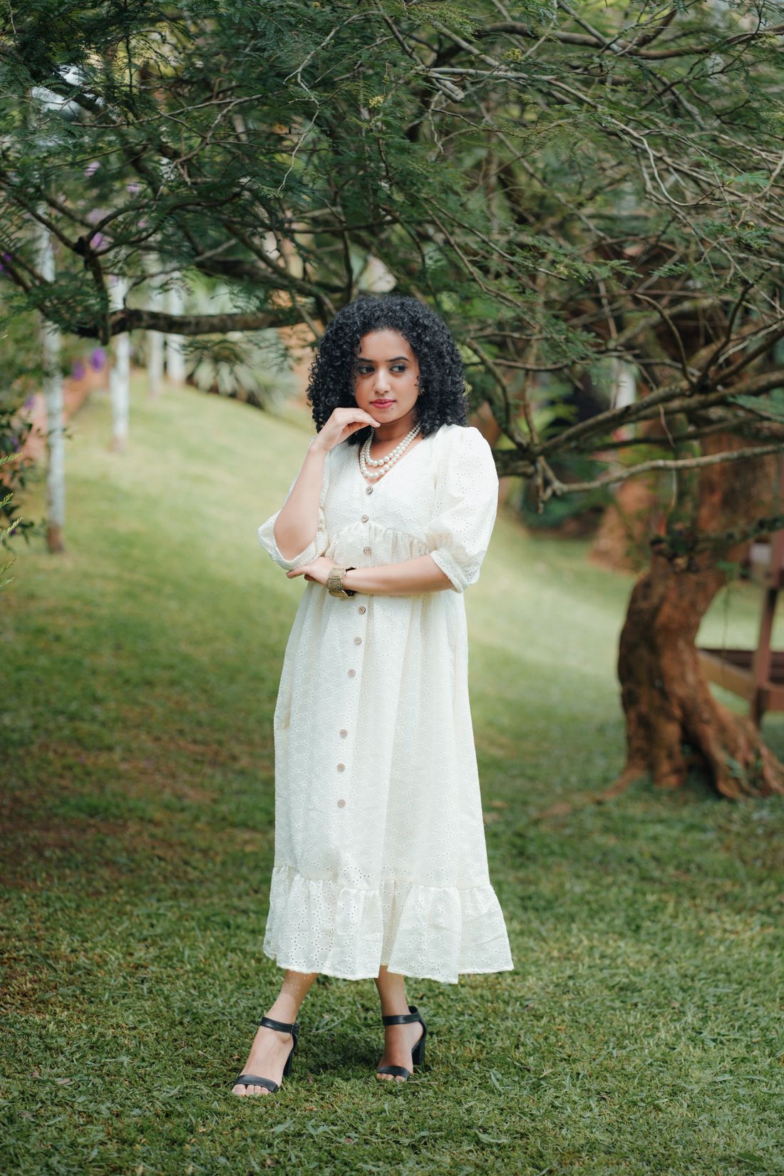 Woman in a white maxi dress in a park