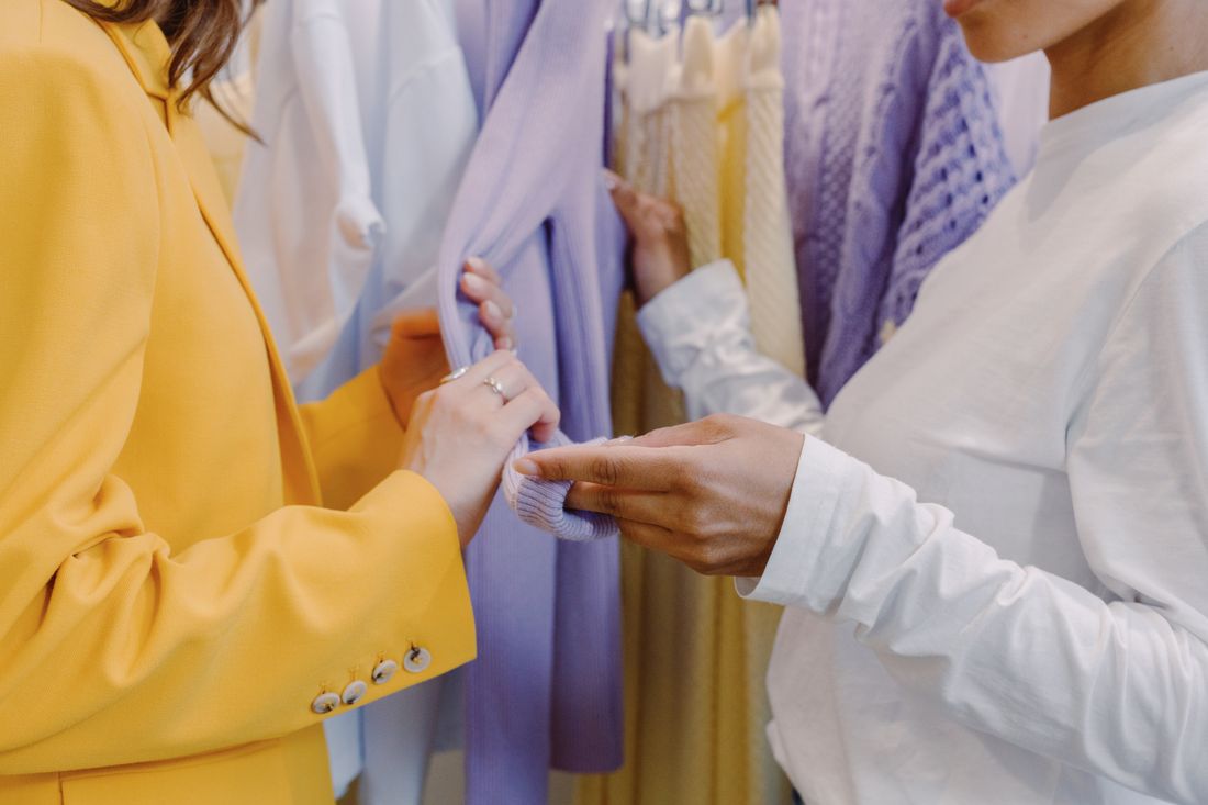 Two women feeling fabric in the NOORA studio